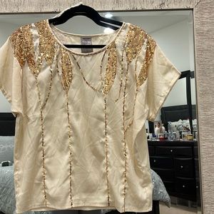 Perfect for holiday parties! Cream top with gold sequins.